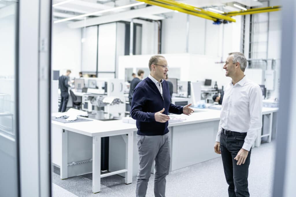 Stefan Dreyer (left) and Adam Baker (right) in one of the workshops for the combustion engine (courtesy of Audi F1)